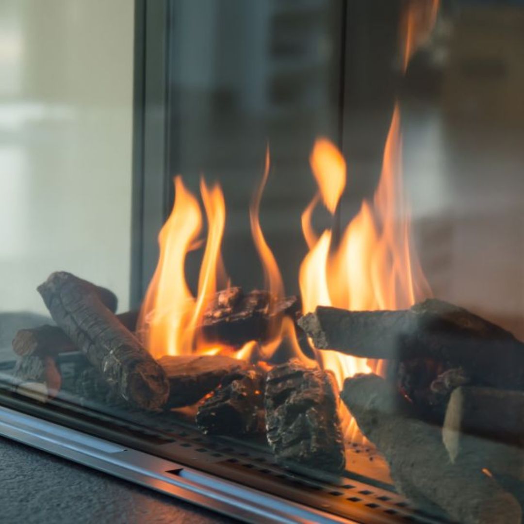 stock photo of a close view of gas flames in a glass gas fireplace